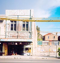 Photo of the Olympia Milk Bar, showing vacant block next door